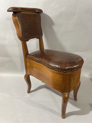 pair of antique wooden chairs with leather upholstered seat