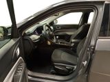 the interior of a car with the door open and the driver ' s seat down