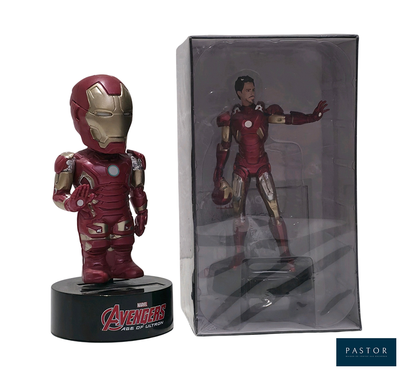figurine of iron man in a box next to it ' s packaging
