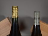 two bottles of wine sitting next to each other on a table