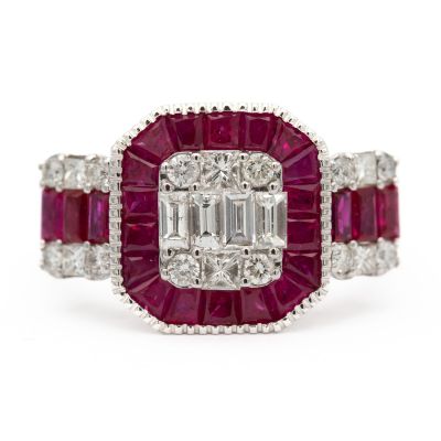 a close up of a diamond and ruby ring on a white background