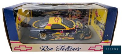 the box is open to show a toy car in it ' s packaging