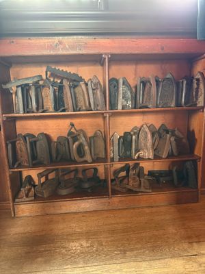 a lot of shoes that are sitting on a book shelf