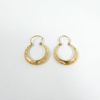 a pair of gold hoop earrings on a white background