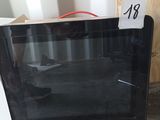a microwave that is sitting on the floor in the room