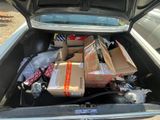 many boxes in the trunk of a car that is full of stuff