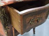 a small wooden table with a drawer on top of it