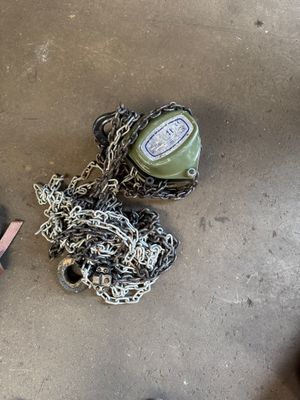 a bottle and chains on the ground next to a pair of shoes