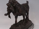bronze statue of a dog holding a duck in its mouth
