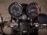 two gauges on the handlebars of a motorcycle