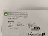 the box is open on a white surface with a green label on it