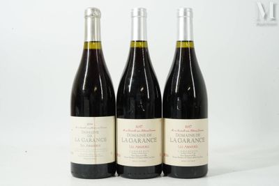 three bottles of wine sitting on top of a white table