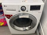 a washer and dryer in the corner of a bathroom