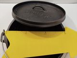 a black pan with a yellow arrow sticking out of it next to a black pan with a yellow arrow sticking out of it