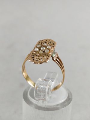 an image of a close up of a ring with pearls on it