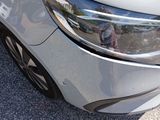 a close up of a car ' s headlight on a parking lot