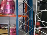 a shelf with a lot of pink plastic containers on it