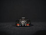 a close up of a toy car on a black surface