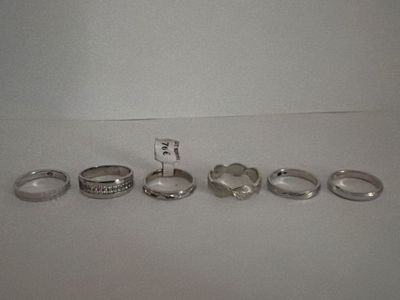several different rings are arranged in a row on a table