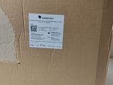 the back of a cardboard box with a sticker on it