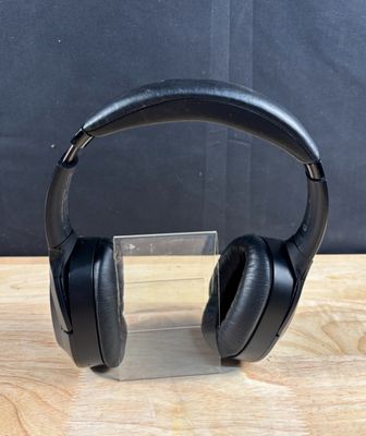 a pair of headphones sitting on top of a wooden table
