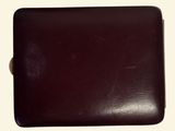 a brown leather wallet sitting on top of a white table