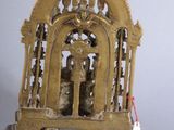 a small statue of a person inside of a cage
