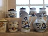 many vases and jars on the counter in this kitchen