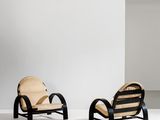 two chairs in a room with a white wall and a white floor