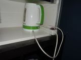 a green and white kettle sitting on a counter