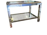 a close up of a metal table with a glass top