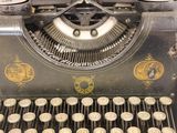 an old typewriter with a lot of buttons on it