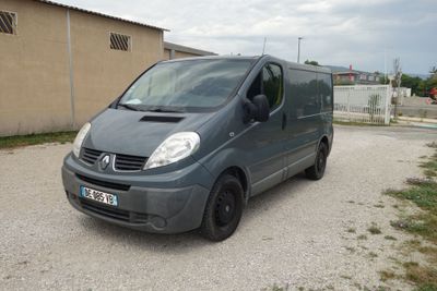 a grey van that is parked in a parking lot