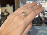 a woman ' s hand with a ring on it