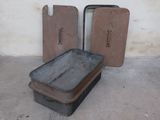 two old pans sitting on the floor next to each other