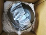 a cardboard box with a helmet in it that is wrapped in plastic