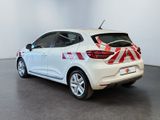 the rear end of a white car with a red and white design on it