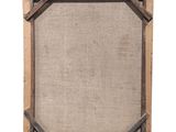 an old wooden frame with a piece of burlock on it