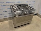 a stainless steel stove with four burners in a room