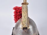 a silver helmet with a red pom pom on top of it