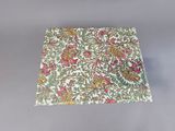 a close up of a square piece of cloth with flowers on it