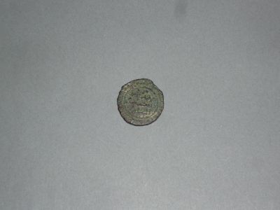 a close up of a coin on a table with a white background