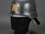 an old helmet with a gold emblem on it sitting on a mannequin head