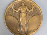 an image of a gold medal with a woman holding a bird