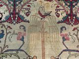 an antique persian rug with a floral design on a beige ground