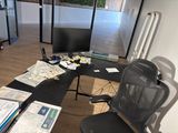 a desk with a computer and a monitor on it