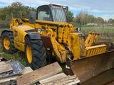 a bulldozer that is parked next to a pile of wood