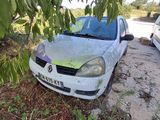 a white car that is parked under a tree