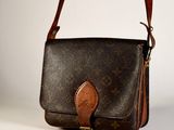 a brown and black purse with a brown handle