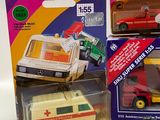 three different toy vehicles in the package on the table